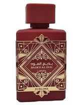 Lattafa Badee Al Oud Sublime unisex eau de parfum bottle with red geometric design, 3.4 oz, woody aromatic fragrance with apple, litchi, rose, plum, jasmine, moss, vanilla, and patchouli notes.